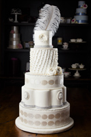 Five tier cake with ruffles antique cameos and silver accented ranunculus flowers