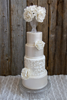 Hand painted pearl finished tiers topped with a large bouquet of sugar flowers