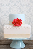 Vintage blue and cream cake with red rose sugar flower.